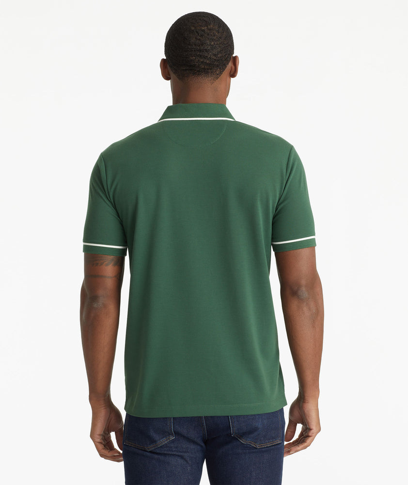 Model wearing an UNTUCKit Dark Green No Sweat Polo with Tipping
