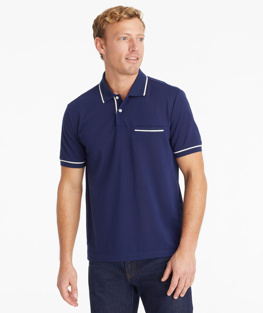 Model wearing an UNTUCKit Navy No Sweat Polo with Tipping