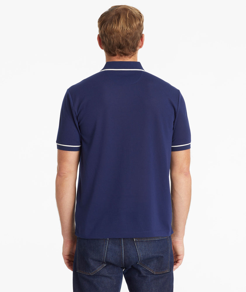 Model wearing an UNTUCKit Navy No Sweat Polo with Tipping