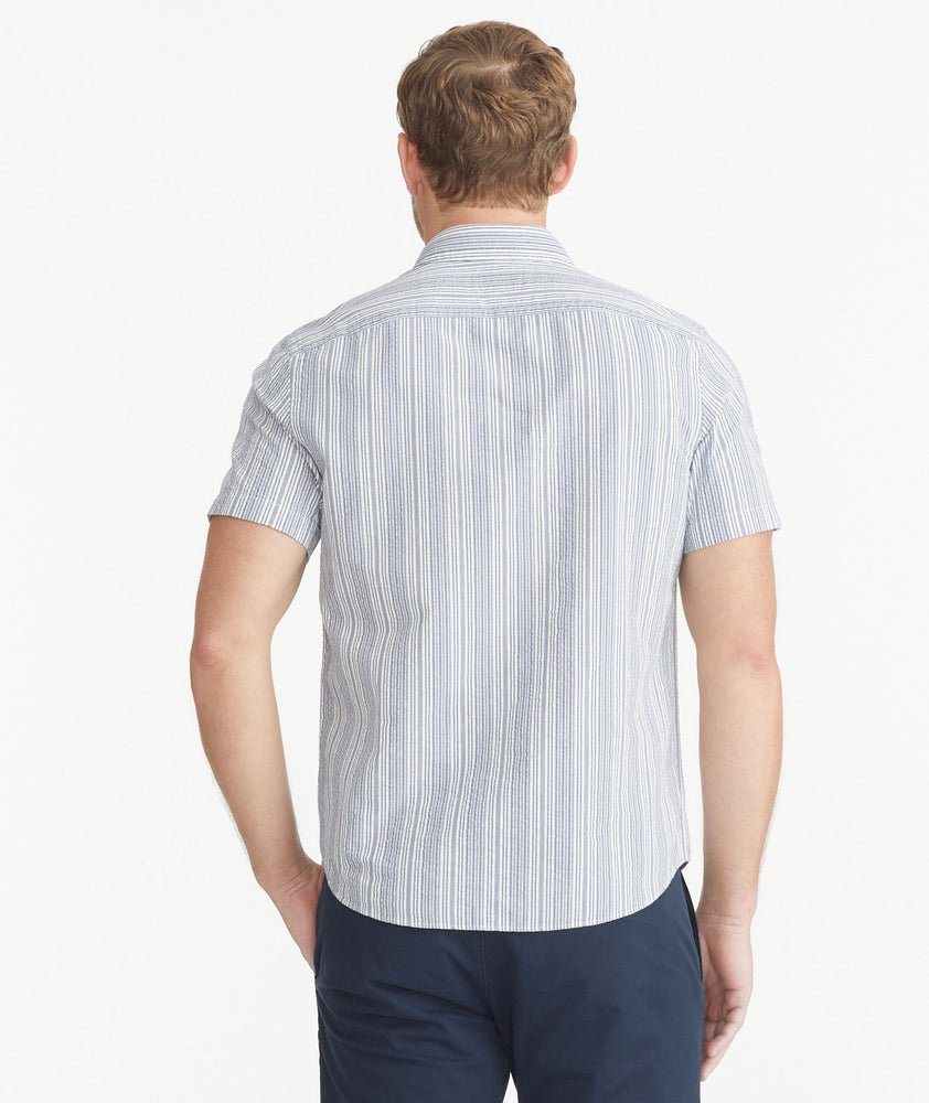 Model is wearing UNTUCKit Blue and White Cotton Seersucker Short-Sleeve Caleb Shirt.