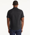 Model wearing an UNTUCKit Black Wrinkle-Resistant Linen Short Sleeve Cameron Shirt