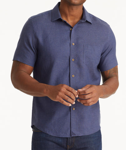 Model wearing an UNTUCKit Navy Wrinkle-Resistant Linen Short Sleeve Cameron Shirt