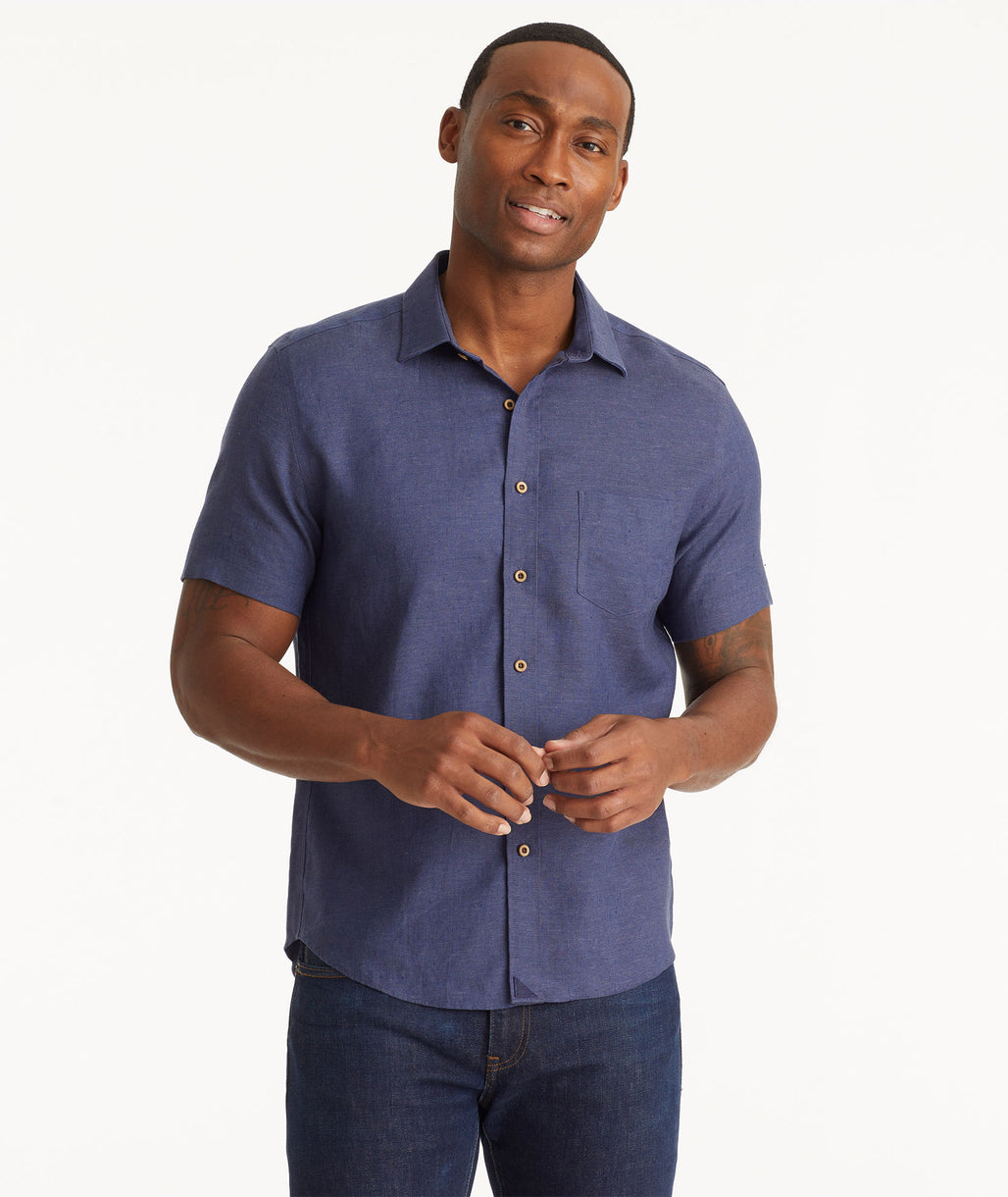 Model wearing an UNTUCKit Navy Wrinkle-Resistant Linen Short Sleeve Cameron Shirt