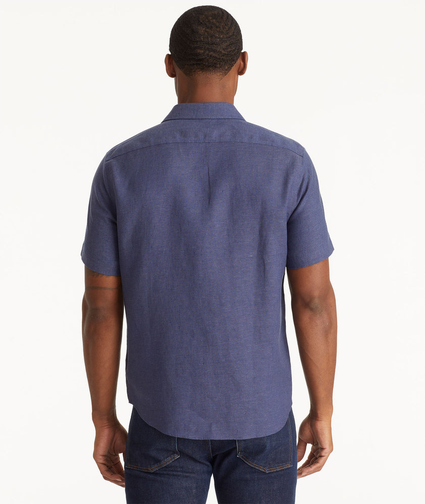 Model wearing an UNTUCKit Navy Wrinkle-Resistant Linen Short Sleeve Cameron Shirt