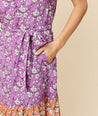 Model is wearing UNTUCKit purple and orange V- Neck Flounce Hem Dakaota Dress.