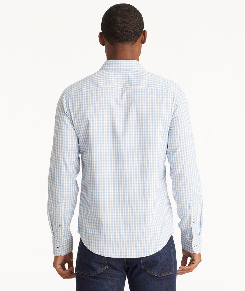 Model wearing an UNTUCKit Light Blue Wrinkle-Free Performance Duras Shirt