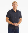 Model wearing an UNTUCKit Black Wrinkle-Free Performance Short Sleeve Gironde Shirt