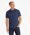 Model wearing an UNTUCKit Navy Wrinkle-Free Performance Short Sleeve Gironde Shirt