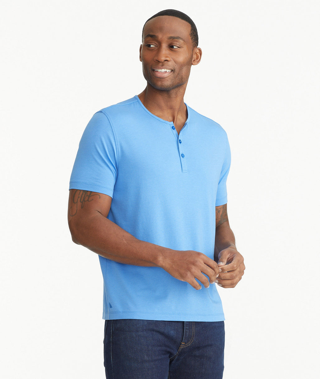 Model wearing an UNTUCKit Bright Blue Essential Henley in EcoSoft™.