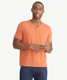 Model wearing an UNTUCKit Orange Essential Henley in EcoSoft™.