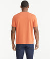 Model wearing an UNTUCKit Orange Essential Henley in EcoSoft™.