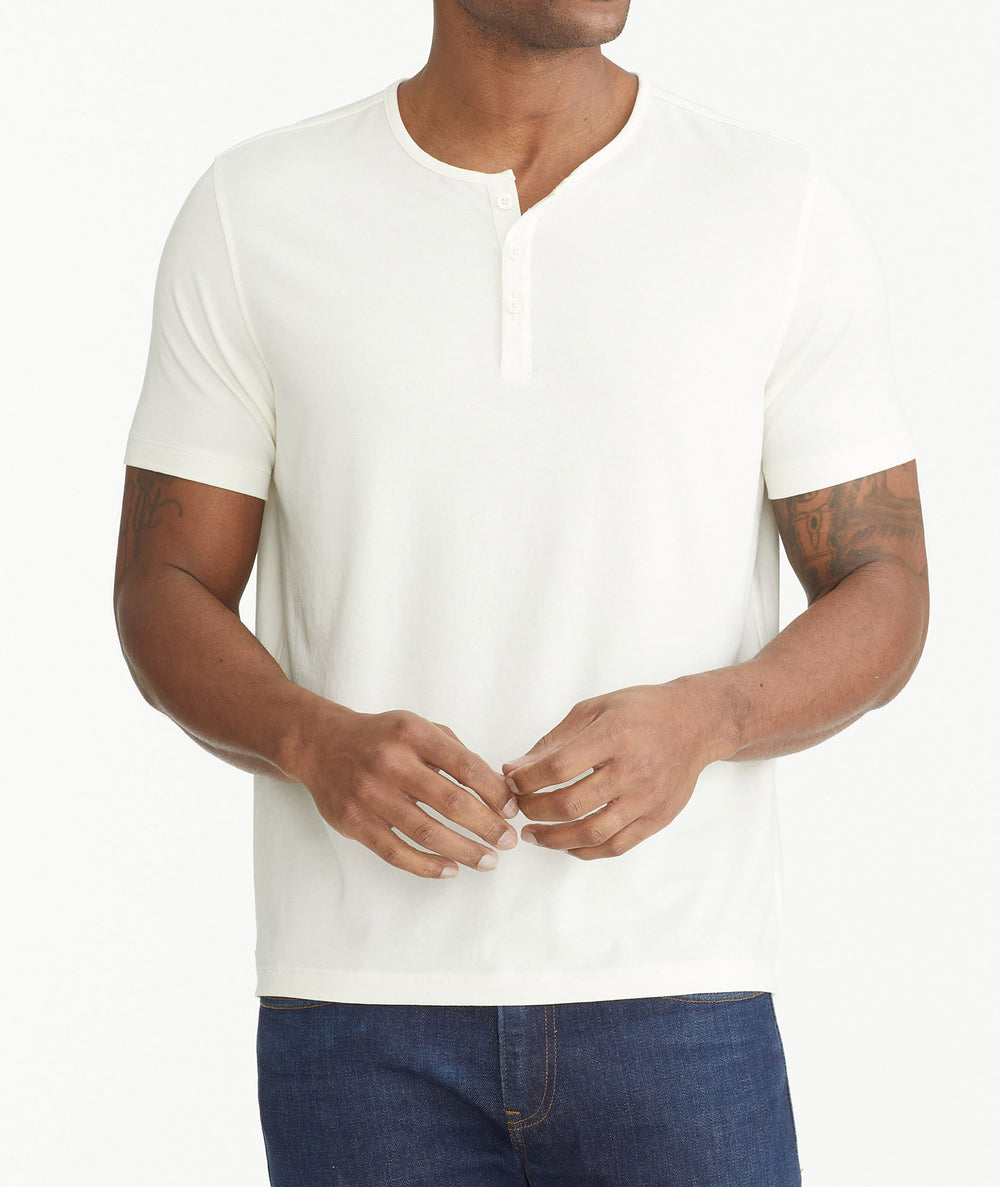 Model wearing an UNTUCKit white Essential Henley in EcoSoft™.