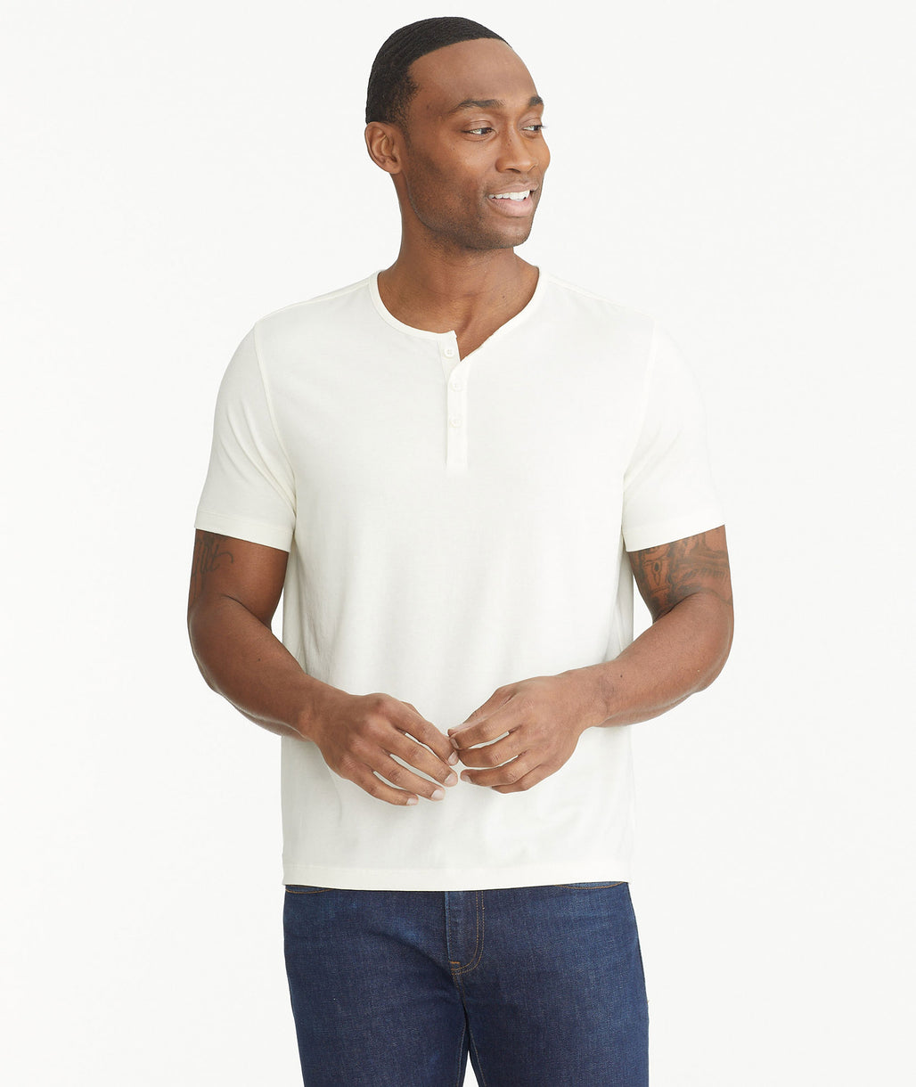 Model wearing an UNTUCKit white Essential Henley in EcoSoft™.