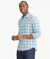 Model is wearing UNTUCKit Teal Navy & White Check Wrinkle-Free Graciano Shirt.