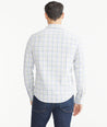 Model is wearing UNTUCKit Lilac & Olive Check Wrinkle-Free Performance Hawkins Shirt.