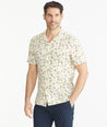 Model is wearing UNTUCKit Tan Floral Linen Short-Sleeve Heaton Shirt.