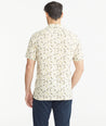 Model is wearing UNTUCKit Tan Floral Linen Short-Sleeve Heaton Shirt.