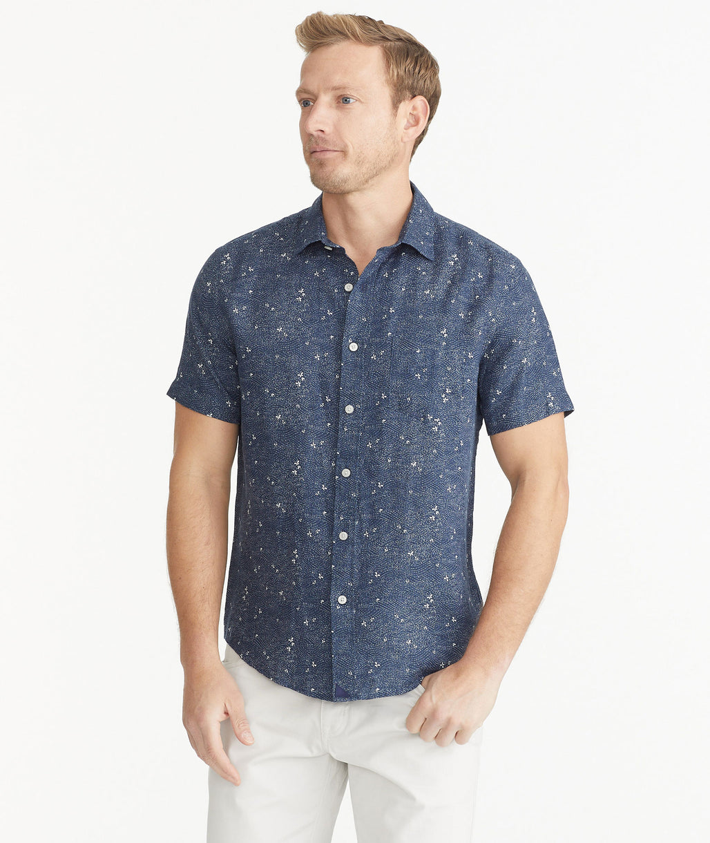 Model is wearing UNTUCKit Navy Butterfly Print Linen Short-Sleeve Hopper Shirt