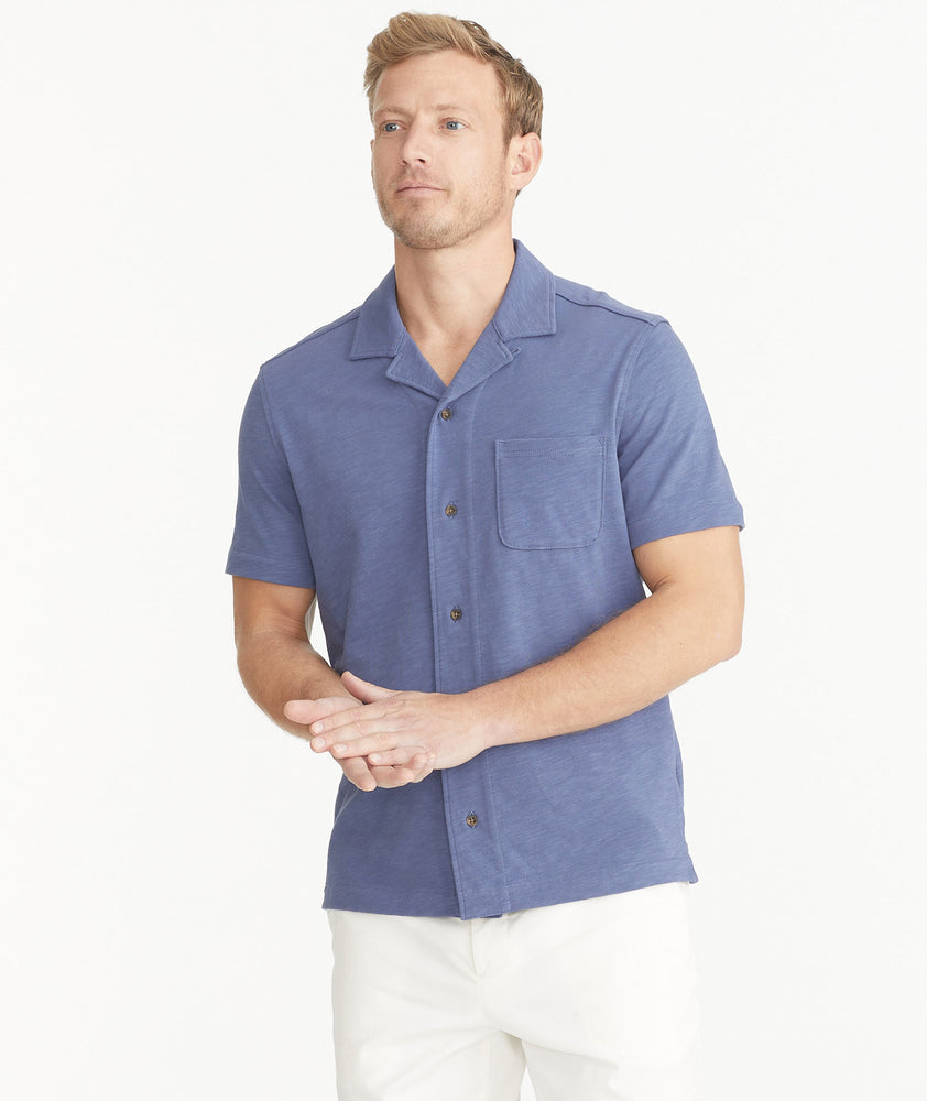Model is wearing UNTUCKit Blue Indigo Cotton Slub Resort Shirt.