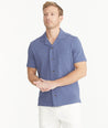 Model is wearing UNTUCKit Blue Indigo Cotton Slub Resort Shirt.