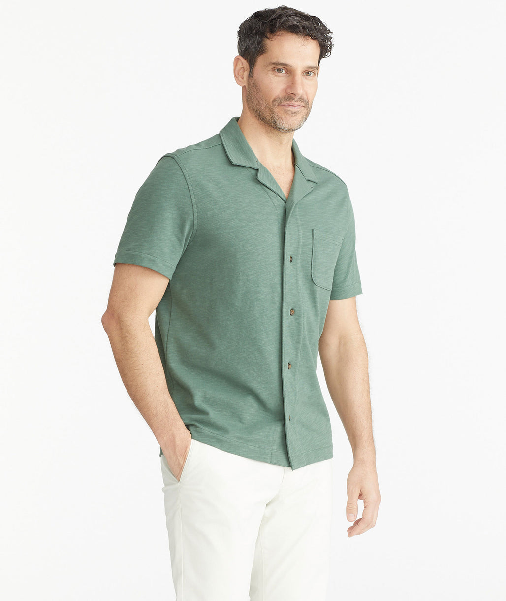 Model is wearing UNTUCKitDuck Green Cotton Slub Resort Shirt.