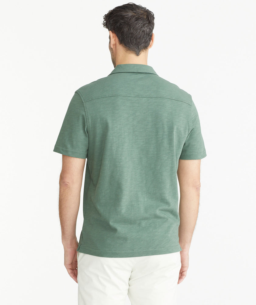 Model is wearing UNTUCKitDuck Green Cotton Slub Resort Shirt.