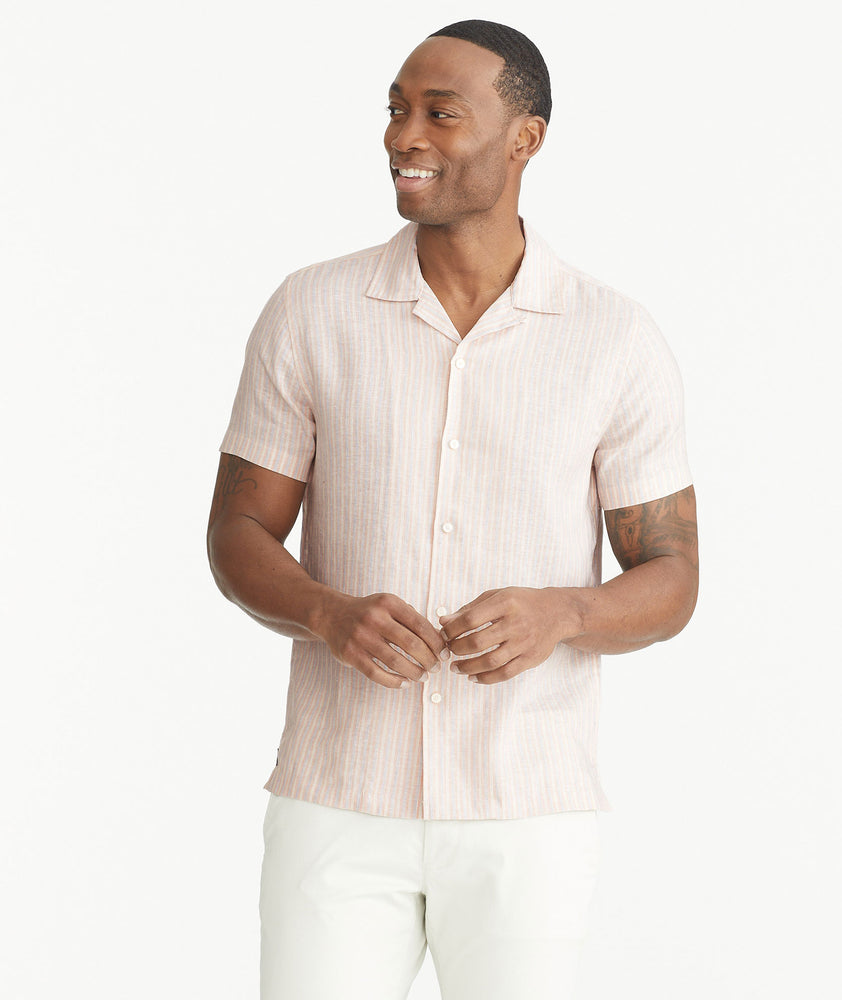 Model is wearing UNTUCKit Pink Wrinkle-Resistant Linen Short-Sleeve Lenora Shirt