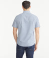 Model is wearing UNTUCKit Teal & Navy Check Wrinkle-Free Short-Sleeve Melvald Shirt.