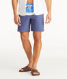 Model wearing UNTUCKit Mid Blue 8-Inch Recycled Board Shorts