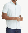 Model is wearing UNTUCKit Solid Pale Blue Cotton Seersucker Short-Sleeve Pavao Shirt. 