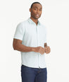 Model is wearing UNTUCKit Solid Pale Blue Cotton Seersucker Short-Sleeve Pavao Shirt.