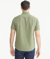 Model is wearing UNTUCKit Moss Green Cotton Seersucker Short-Sleeve Pavao Shirt.