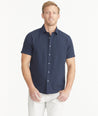 Model is wearing UNTUCKit Navy Cotton Seersucker Short-Sleeve Pavao Shirt.