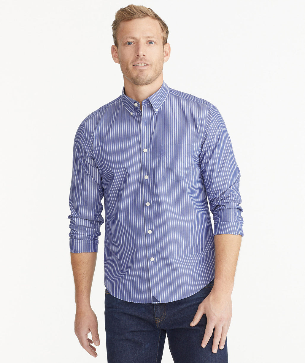 Model is wearing UNTUCKit Navy Stripe Wrinkle-Free Ribolla Shirt.