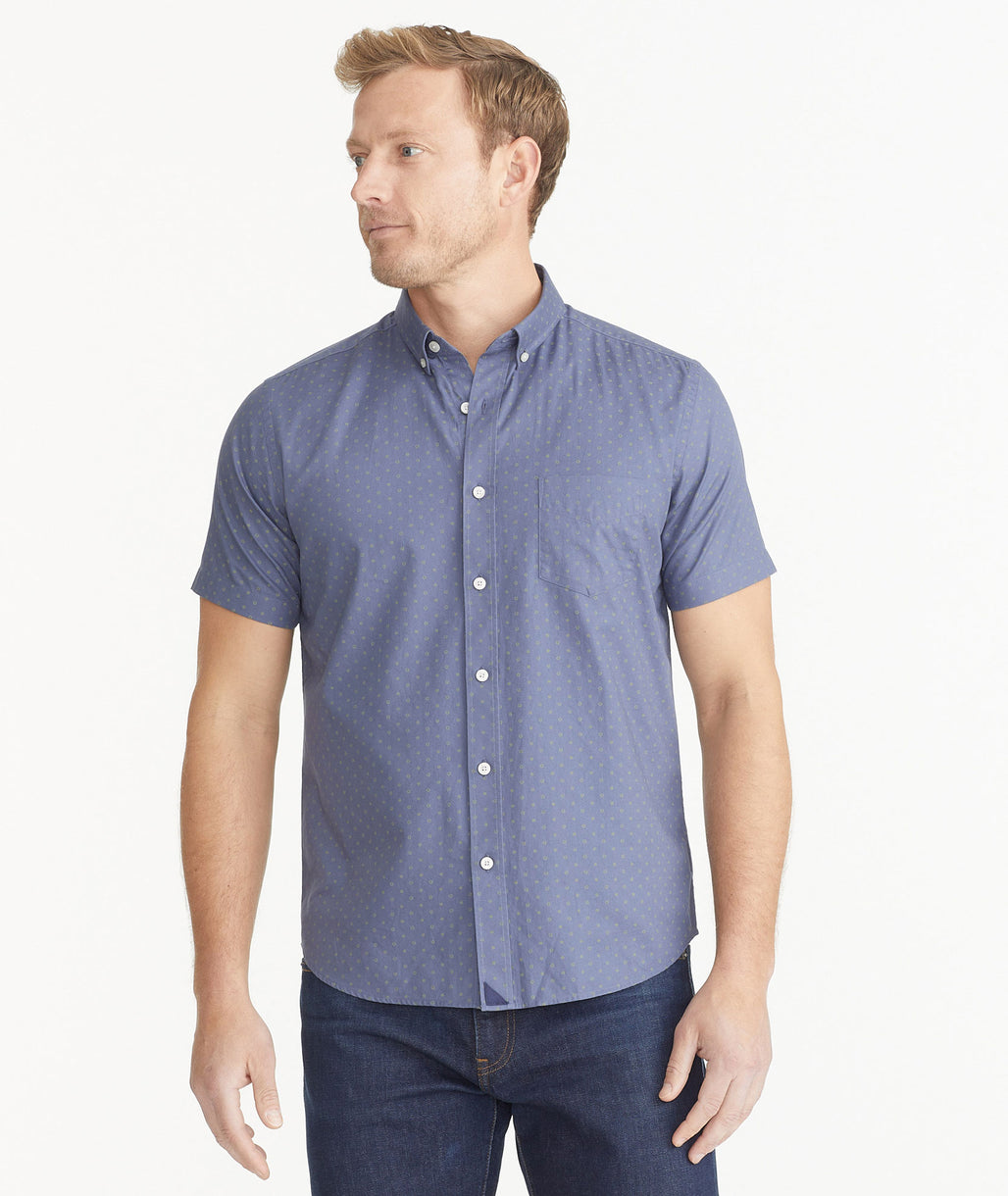 Model is wearing UNTUCKit Blue With Olive Dots Cotton Short-Sleeve Sinclar Shirt.
