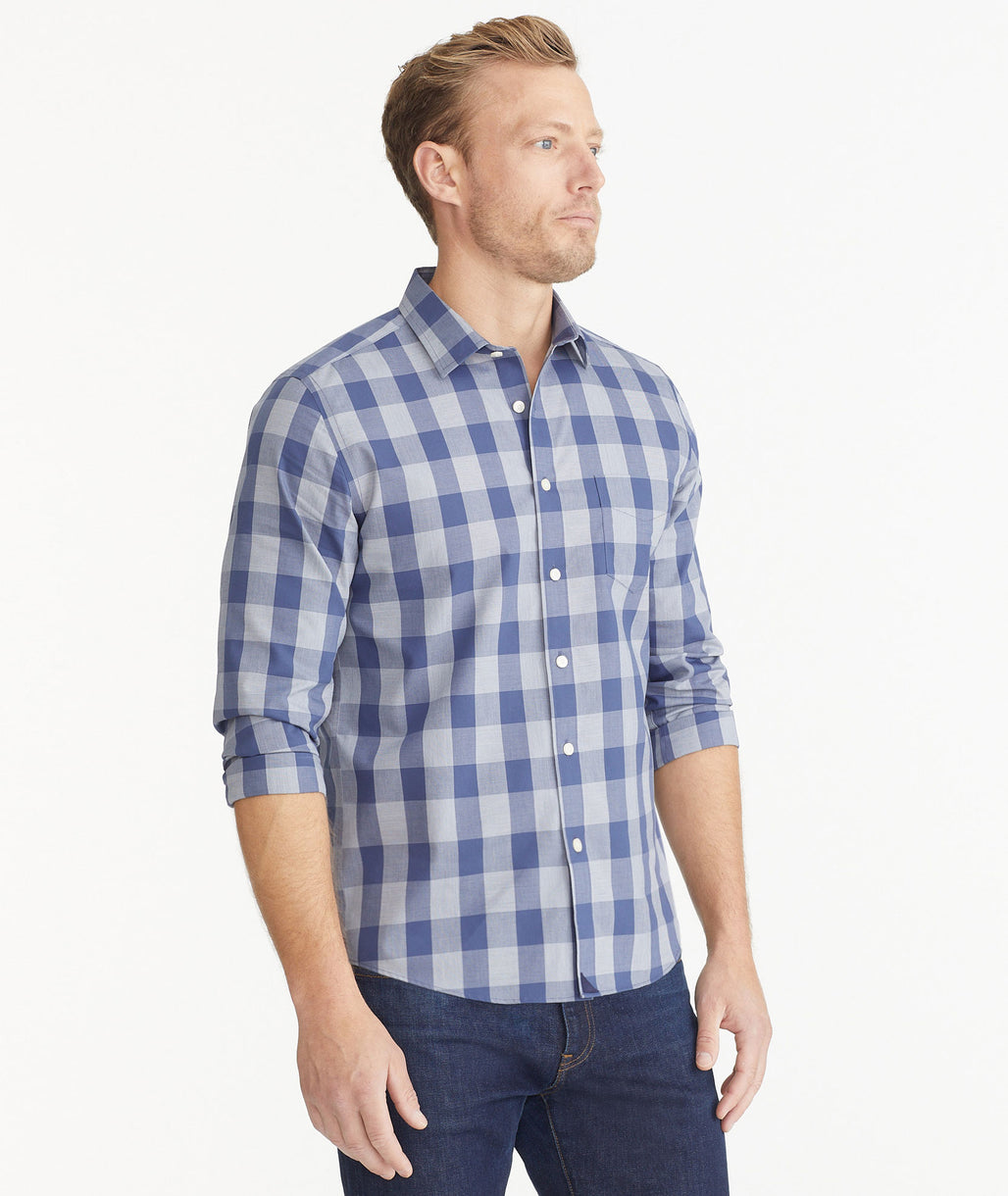 Model is wearing UNTUCKit Navy & Gray Buffalo Check Wrinkle-Free Wheeler Shirt.