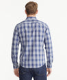 Model is wearing UNTUCKit Navy & Gray Buffalo Check Wrinkle-Free Wheeler Shirt.
