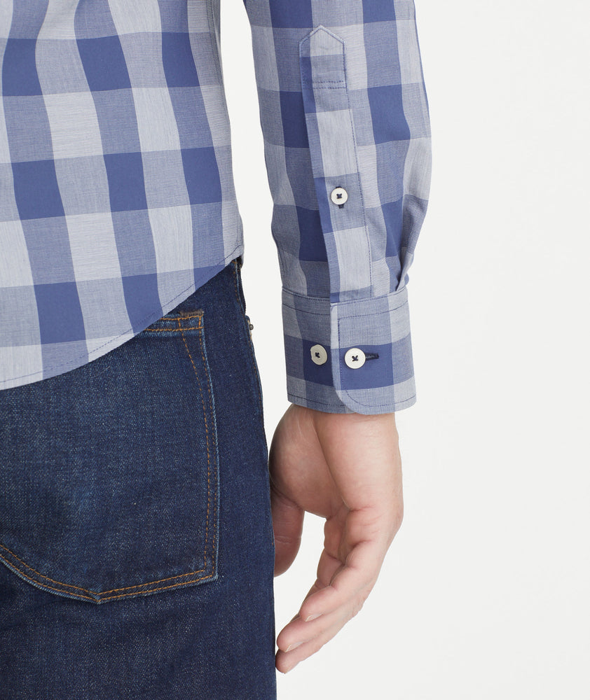 Model is wearing UNTUCKit Navy & Gray Buffalo Check Wrinkle-Free Wheeler Shirt.